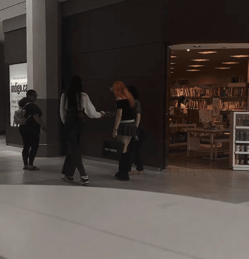 Handing a kindness note in the mall