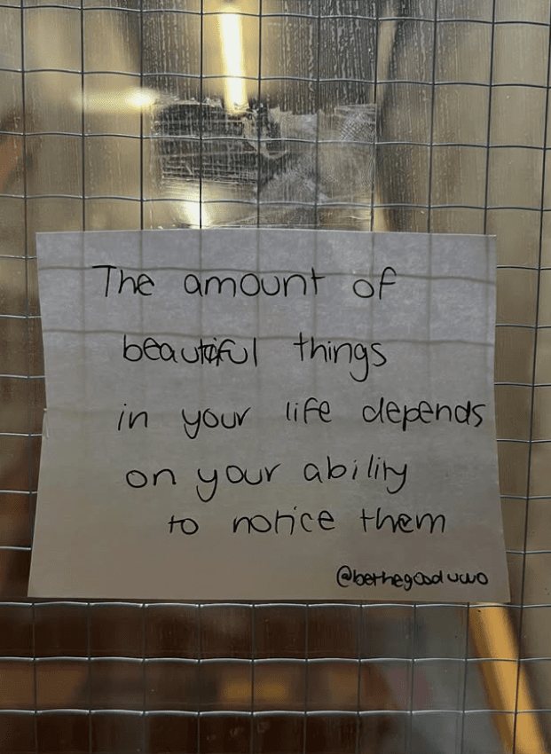 Handwritten kindness note taped on campus